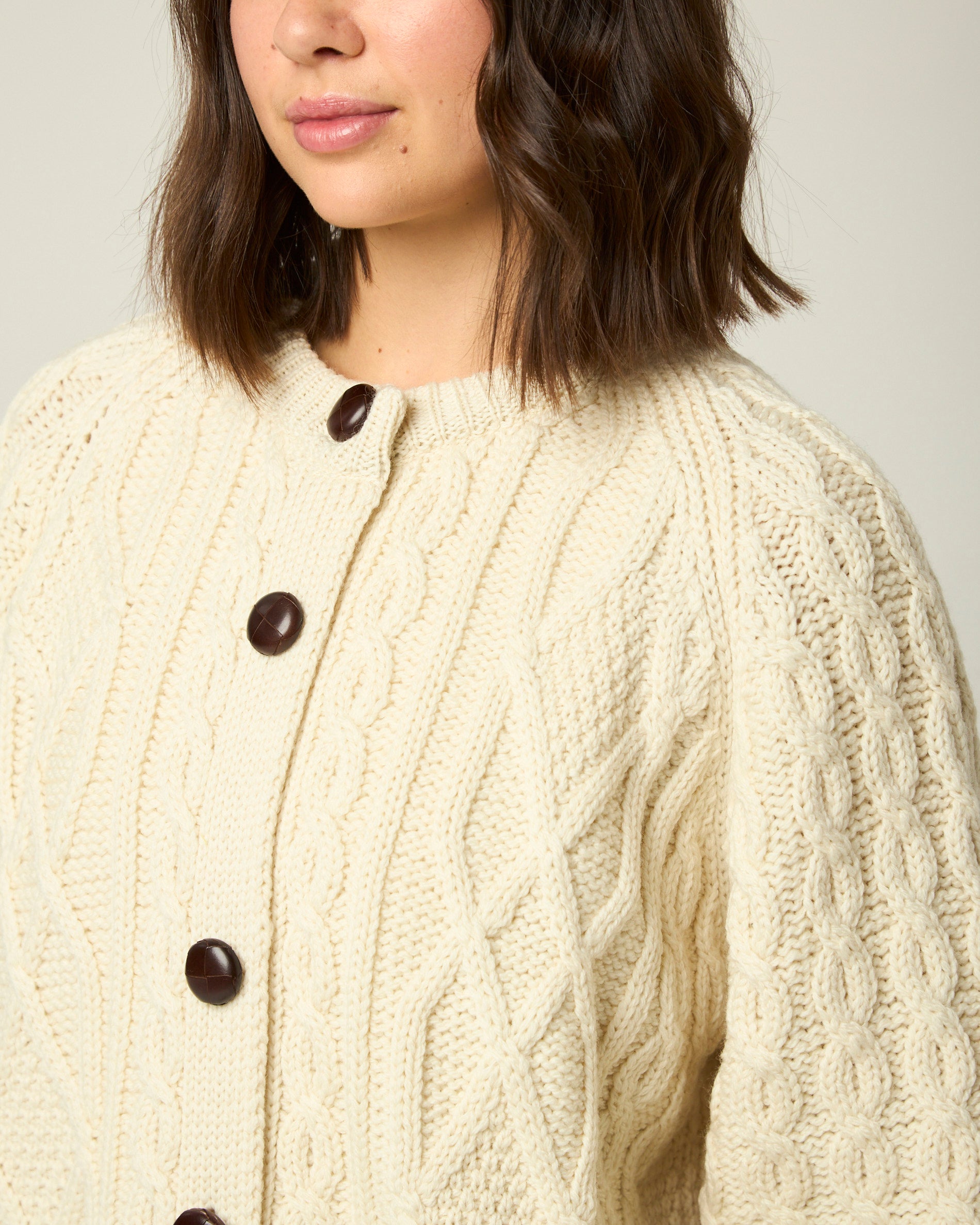 Image of model wearing Beckett Cable Knit Cardigan. 
