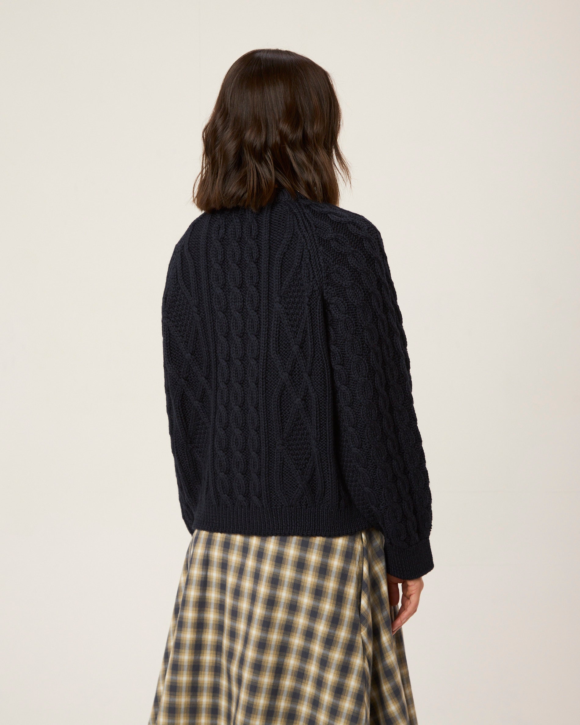 Image of model wearing Beckett Cable Knit Cardigan. 