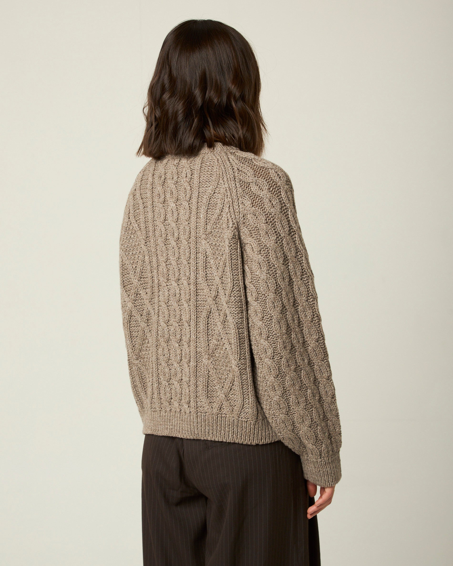 Image of model wearing Beckett Cable Knit Cardigan. 