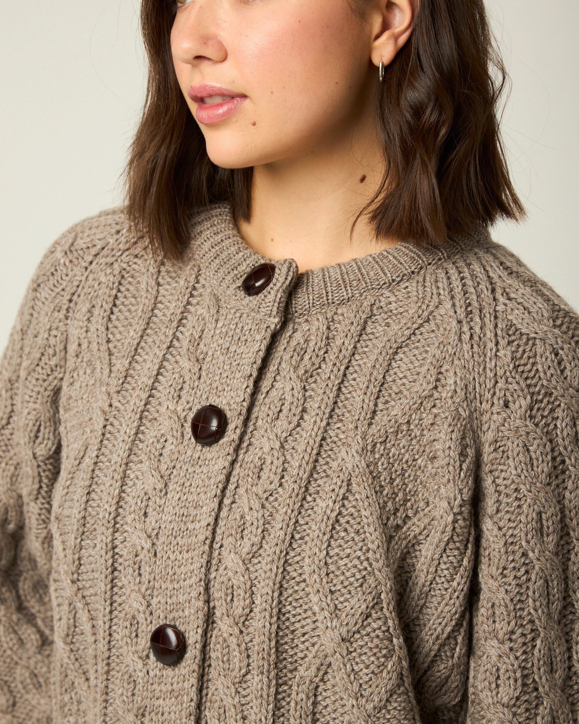 Image of model wearing Beckett Cable Knit Cardigan. 