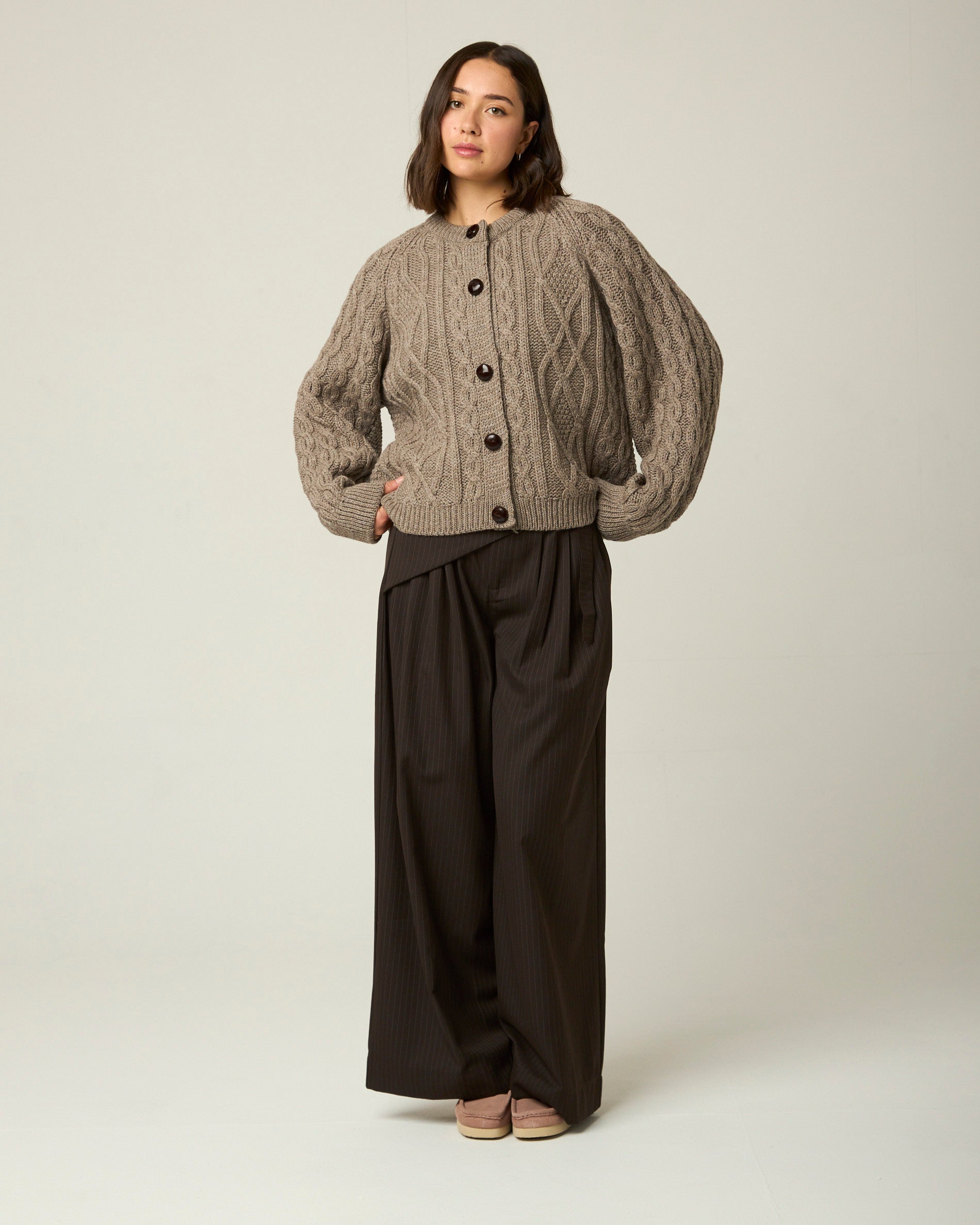 Image of model wearing Beckett Cable Knit Cardigan. 