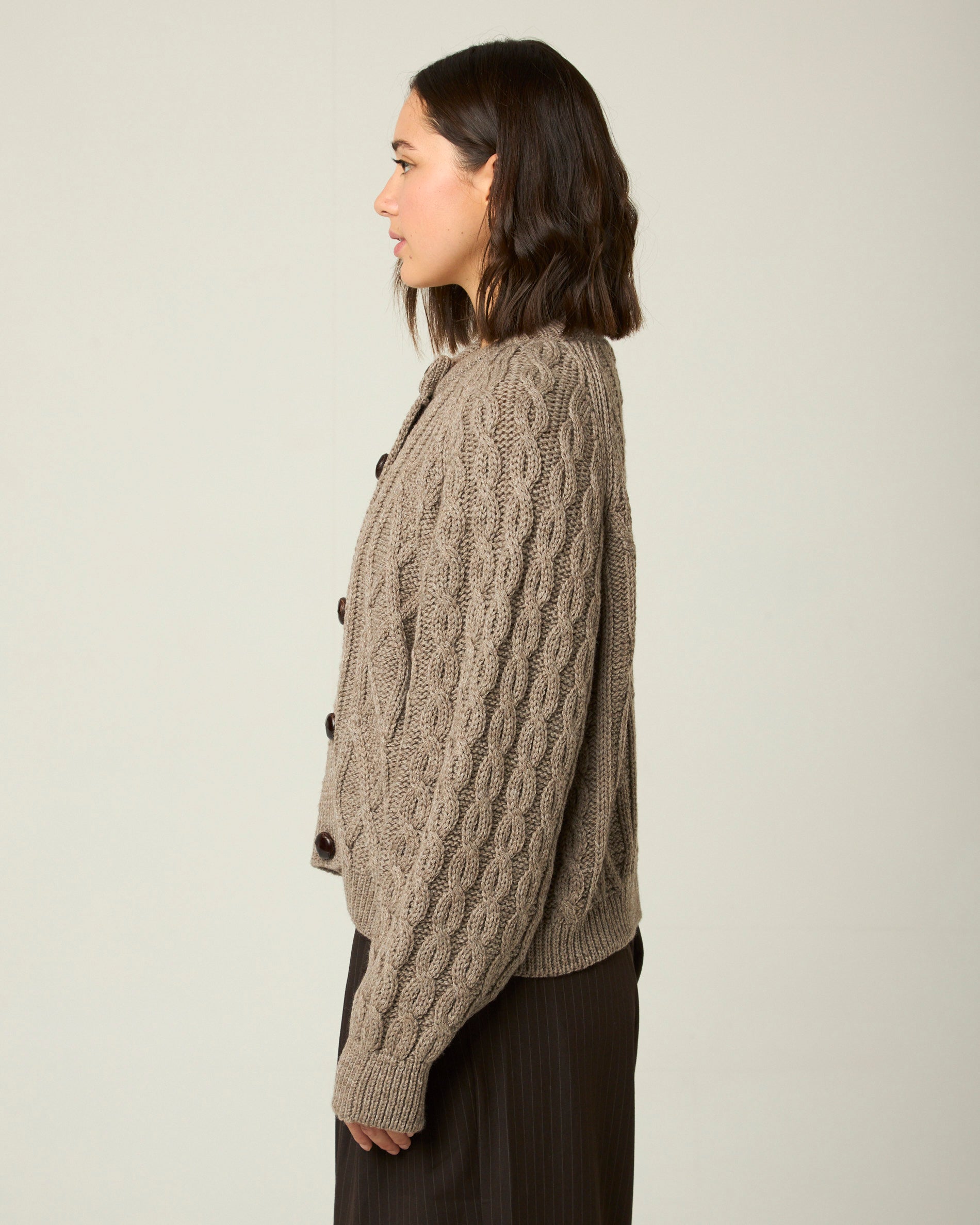 Image of model wearing Beckett Cable Knit Cardigan. 