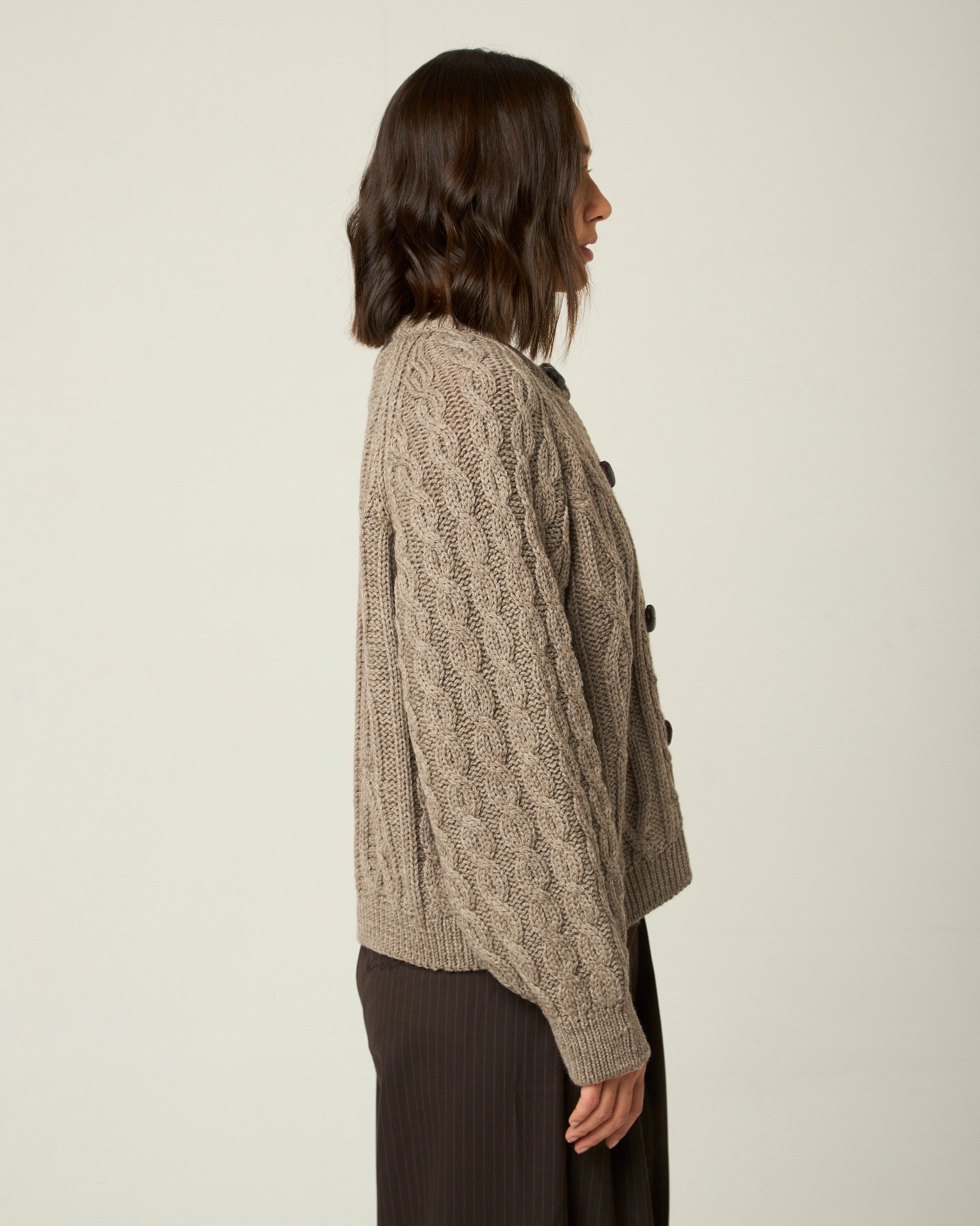 Image of model wearing Beckett Cable Knit Cardigan. 